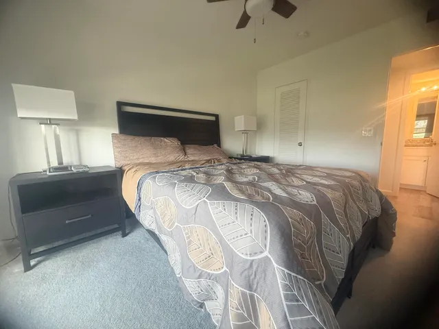 a bedroom with a bed and a lamp