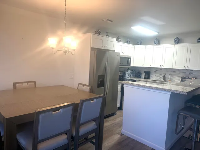 a kitchen with refrigerator and window