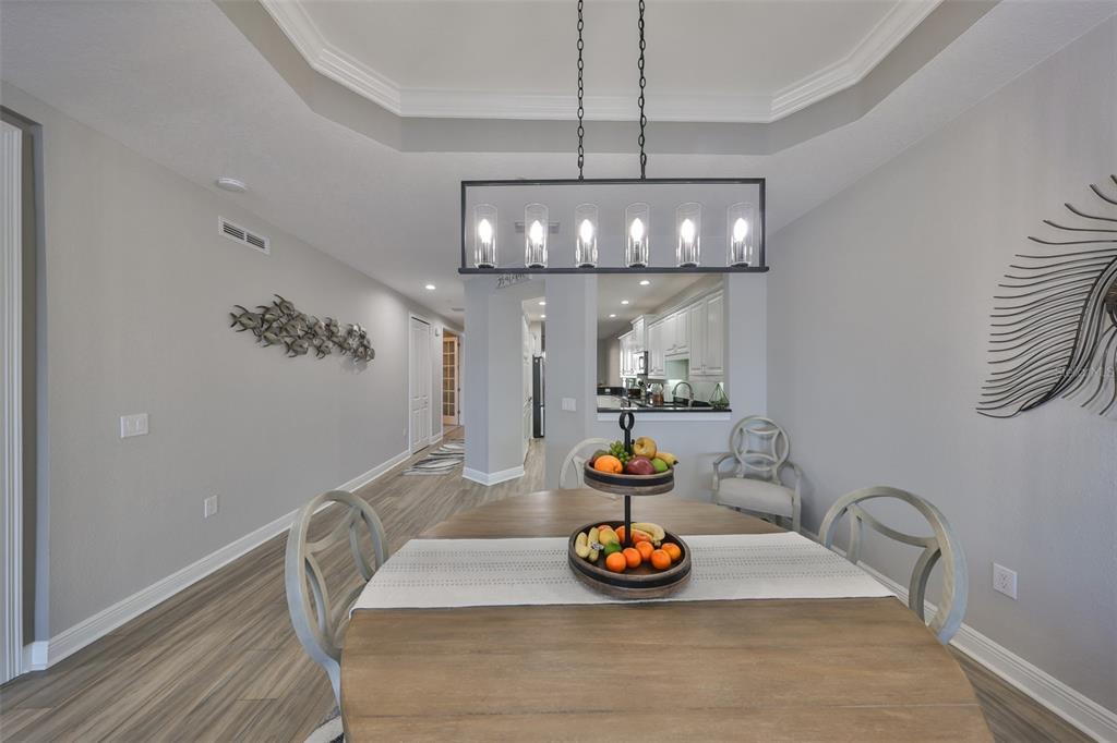 1038 Bellasol Way, Unit 202 Apollo Beach, FL 33572 - Photo 17 of 52 a view of a dining room with furniture