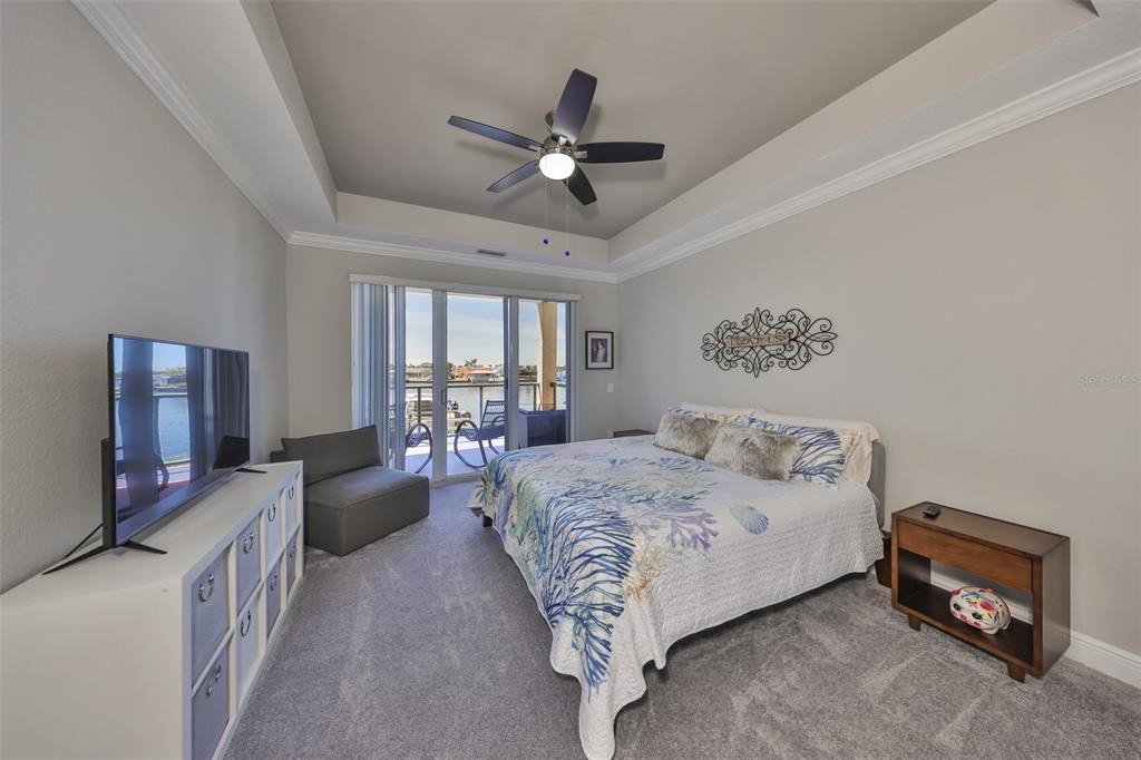 1038 Bellasol Way, Unit 202 Apollo Beach, FL 33572 - Photo 20 of 52 a spacious bedroom with a bed and a couch