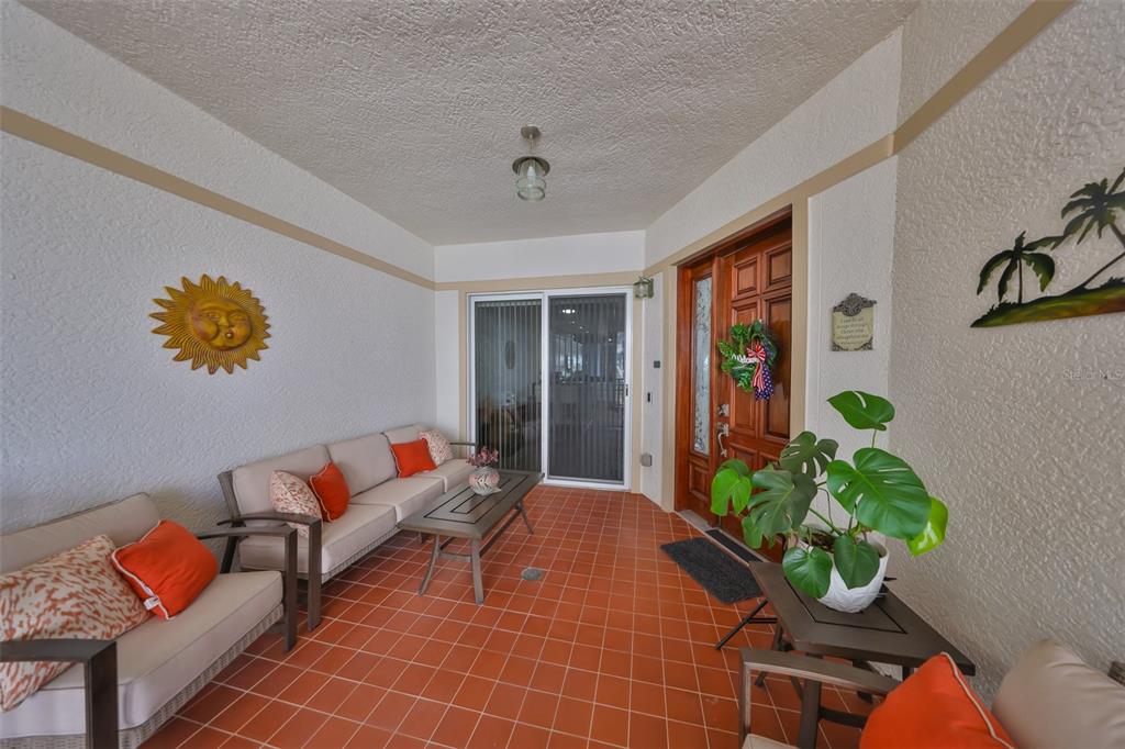 1038 Bellasol Way, Unit 202 Apollo Beach, FL 33572 - Photo 2 of 52 a living room with patio furniture and a potted plant