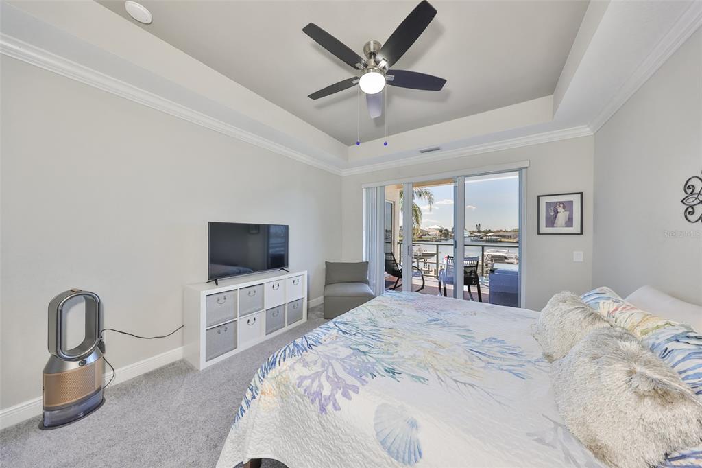 1038 Bellasol Way, Unit 202 Apollo Beach, FL 33572 - Photo 21 of 52 a bedroom with a bed and a flat screen tv