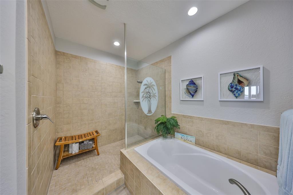 1038 Bellasol Way, Unit 202 Apollo Beach, FL 33572 - Photo 24 of 52 a spacious bathroom with a tub and a shower