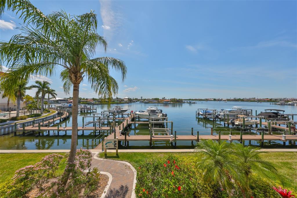 1038 Bellasol Way, Unit 202 Apollo Beach, FL 33572 - Photo 27 of 52 a view of a ocean with boats and palm trees