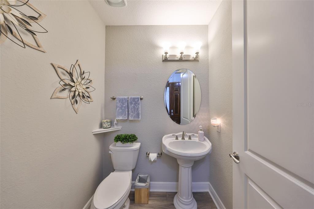1038 Bellasol Way, Unit 202 Apollo Beach, FL 33572 - Photo 28 of 52 a bathroom with a toilet sink and mirror