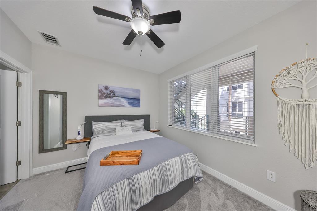 1038 Bellasol Way, Unit 202 Apollo Beach, FL 33572 - Photo 29 of 52 a bedroom with furniture and a window