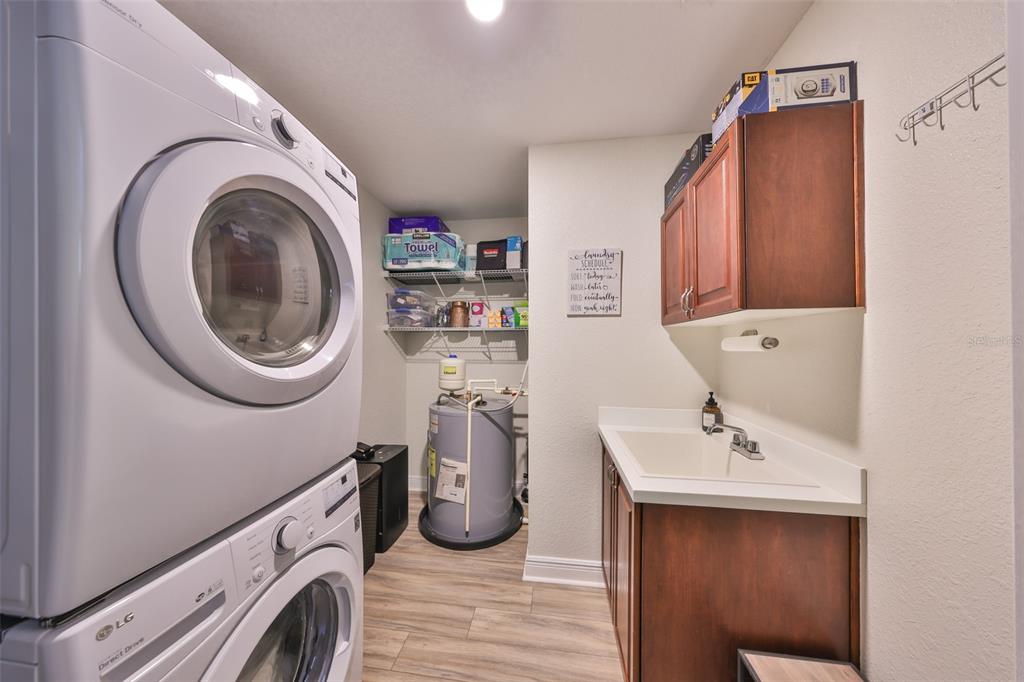 1038 Bellasol Way, Unit 202 Apollo Beach, FL 33572 - Photo 35 of 52 a utility room with sink dryer and washer