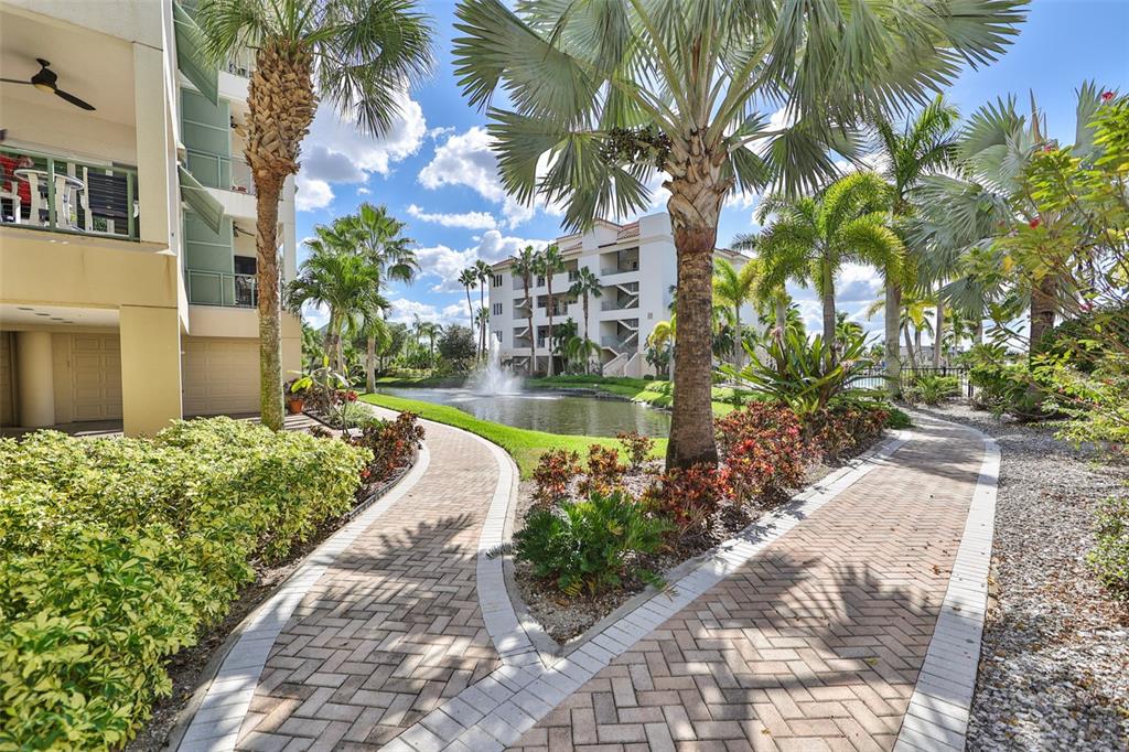 1038 Bellasol Way, Unit 202 Apollo Beach, FL 33572 - Photo 46 of 52 a view of a yard with plants and large trees