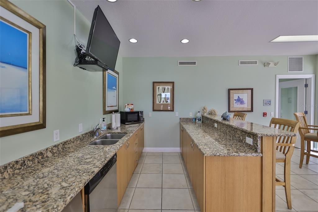 1038 Bellasol Way, Unit 202 Apollo Beach, FL 33572 - Photo 47 of 52 a kitchen with granite countertop a counter top space appliances and cabinets