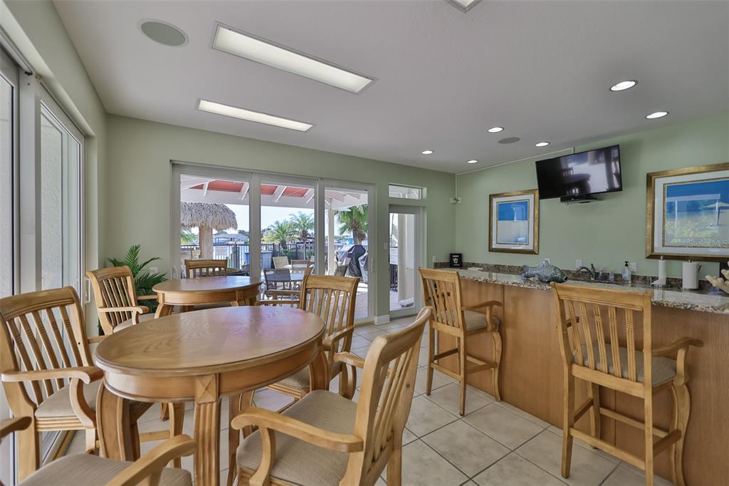 1038 Bellasol Way, Unit 202 Apollo Beach, FL 33572 - Photo 48 of 52 a dining area with stainless steel appliances granite countertop a dining table and chairs