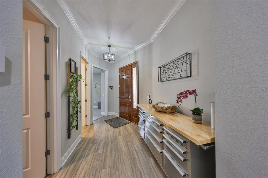 1038 Bellasol Way, Unit 202 Apollo Beach, FL 33572 - Photo 6 of 52 a view of a hallway to a livingroom with furniture