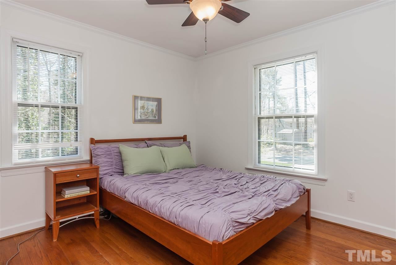 7008 Robbie Drive Raleigh, NC 27607 - Photo 12 of 21 a bedroom with a bed and a chandelier