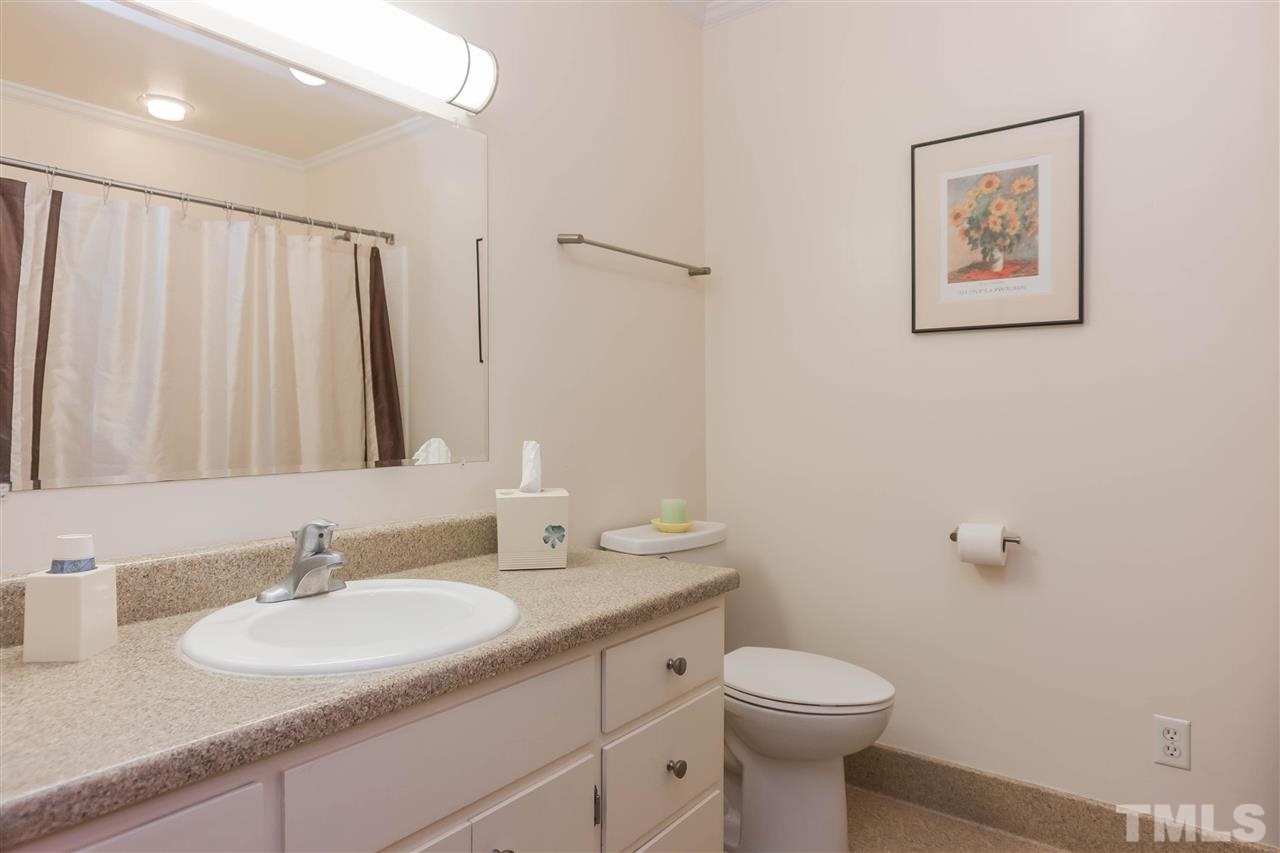 7008 Robbie Drive Raleigh, NC 27607 - Photo 13 of 21 a bathroom with a toilet sink and mirror