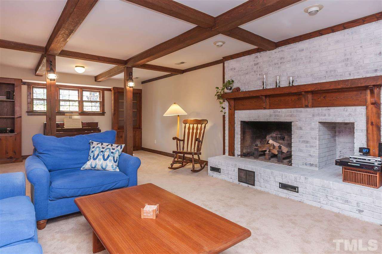 7008 Robbie Drive Raleigh, NC 27607 - Photo 16 of 21 a living room with furniture and a fireplace