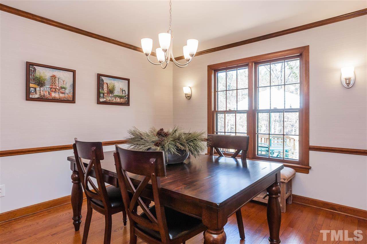 7008 Robbie Drive Raleigh, NC 27607 - Photo 6 of 21 a view of a dining room with furniture window and wooden floor