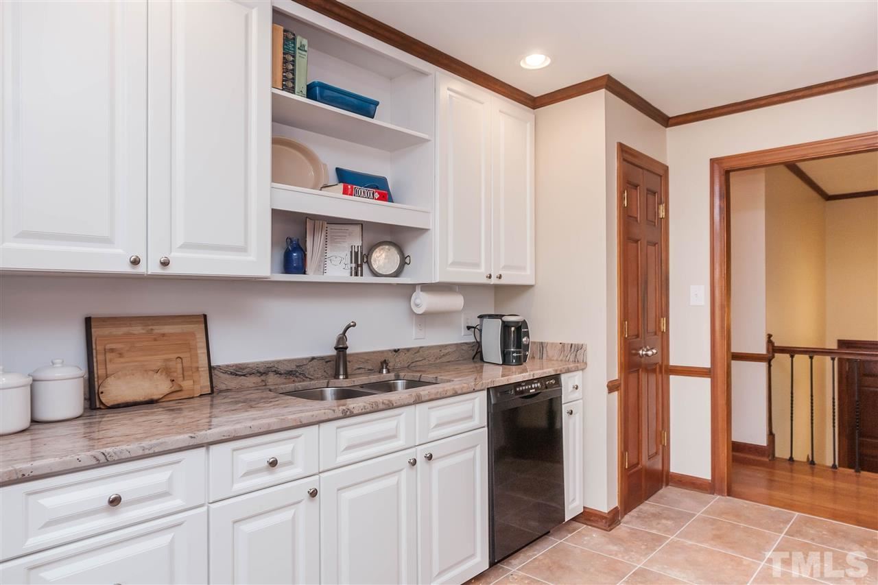 7008 Robbie Drive Raleigh, NC 27607 - Photo 8 of 21 a kitchen with stainless steel appliances granite countertop a refrigerator and a sink