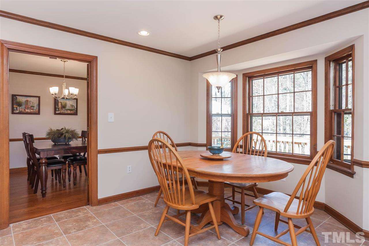 7008 Robbie Drive Raleigh, NC 27607 - Photo 10 of 21 a view of a dining room with furniture and chandelier