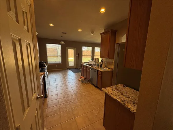 a kitchen with sink cabinets and stainless steel appliances