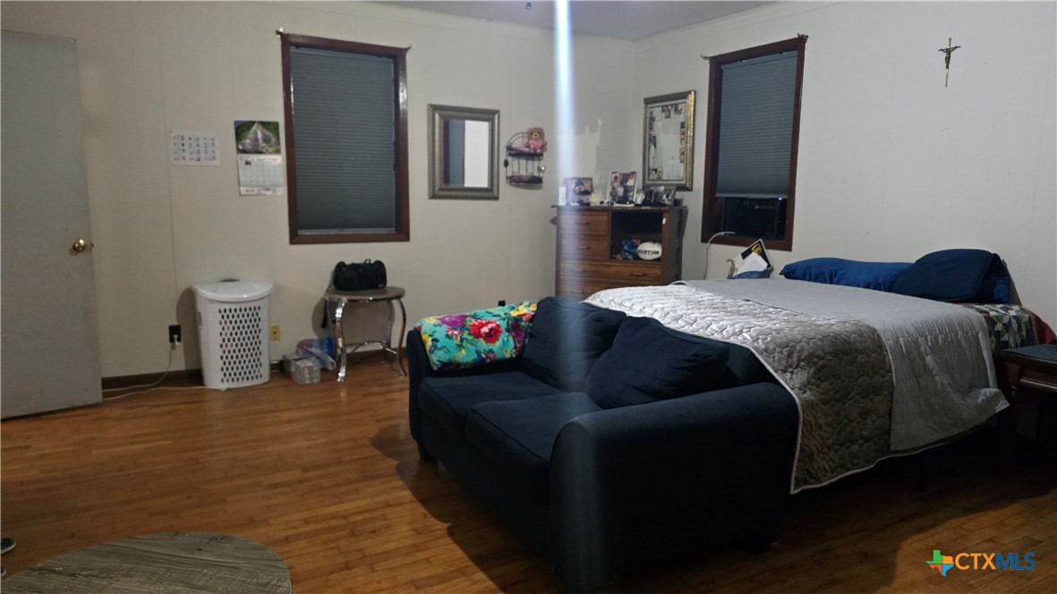 206 Cheeves Avenue Port Lavaca, TX 77979 - Photo 14 of 28 a bed room with a bed mirror and a desk