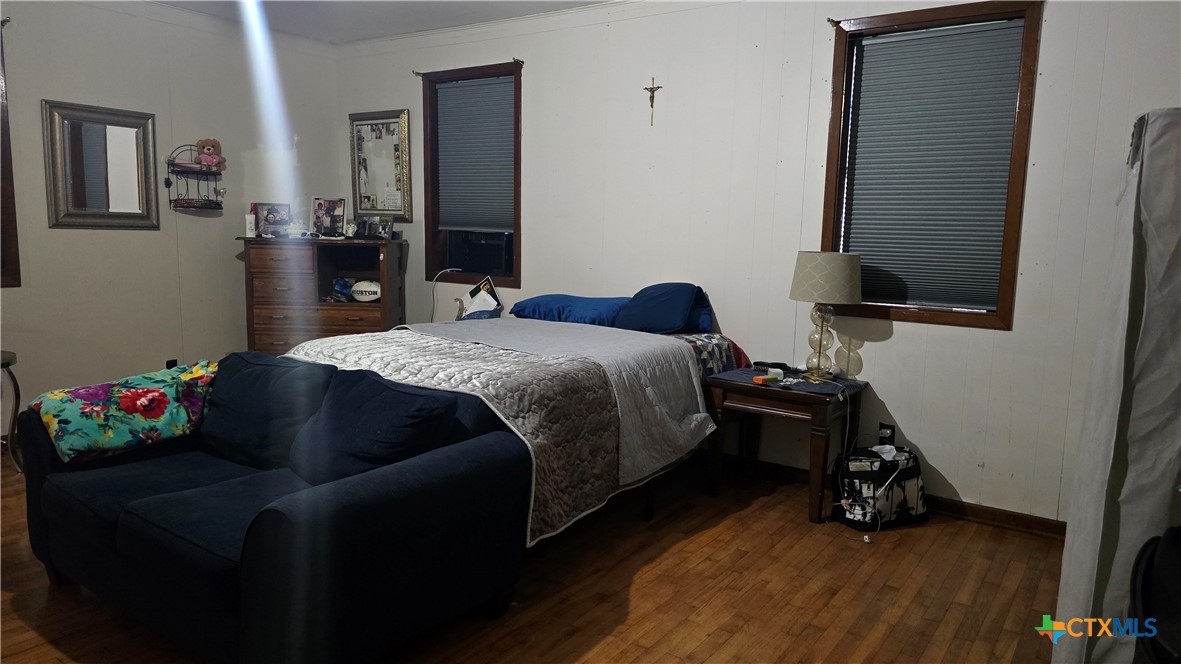 206 Cheeves Avenue Port Lavaca, TX 77979 - Photo 15 of 28 a bedroom with a bed and a flat tv screen