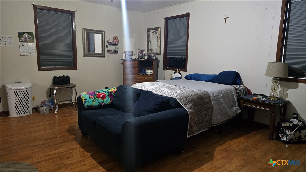 206 Cheeves Avenue Port Lavaca, TX 77979 - Photo 16 of 28 a bedroom with a bed and wooden floor