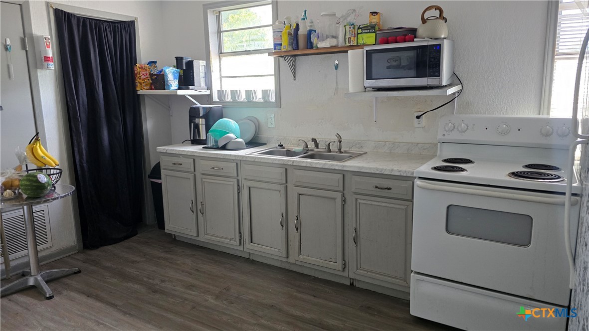 206 Cheeves Avenue Port Lavaca, TX 77979 - Photo 24 of 28 a kitchen with stainless steel appliances white cabinets and a sink