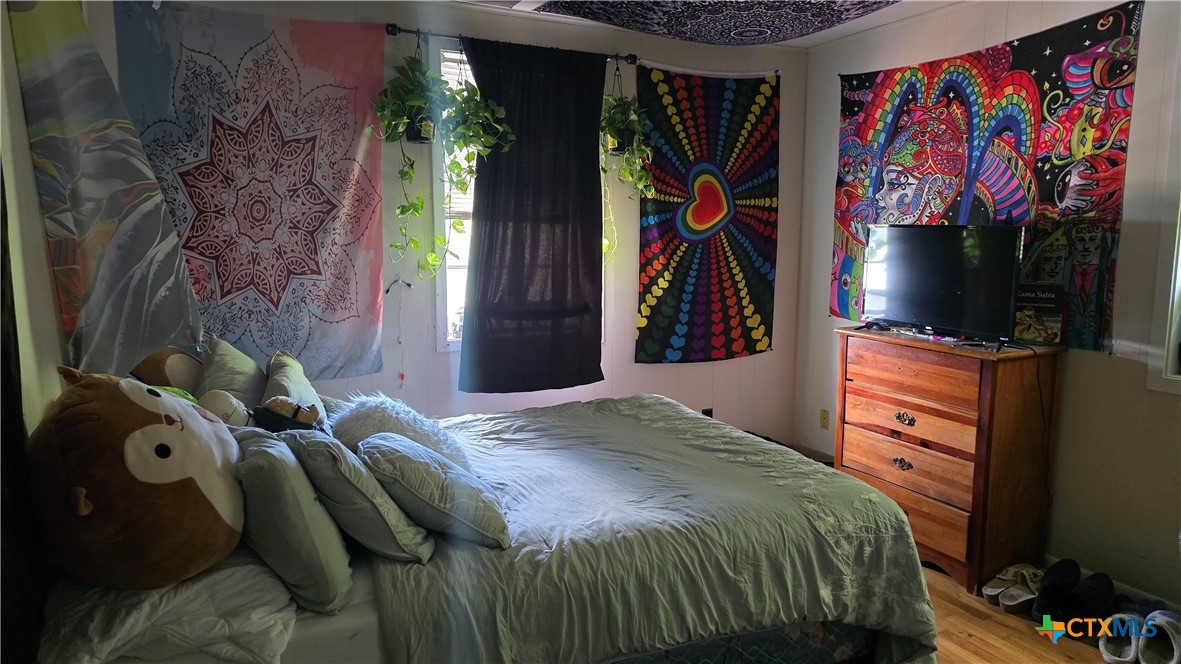 206 Cheeves Avenue Port Lavaca, TX 77979 - Photo 26 of 28 a bedroom with a bed and a flat screen tv