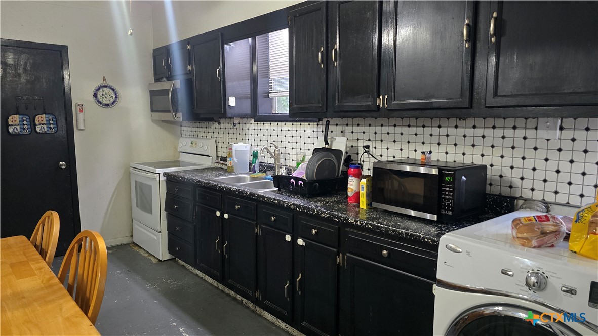 206 Cheeves Avenue Port Lavaca, TX 77979 - Photo 8 of 28 a kitchen with stainless steel appliances granite countertop a sink stove and cabinets
