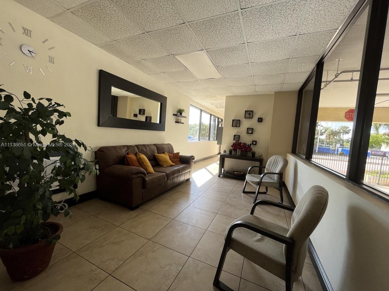 6445 Indian Creek Drive, Unit B16 Miami Beach, FL 33141 - Photo 15 of 18 a living room with furniture and a large window