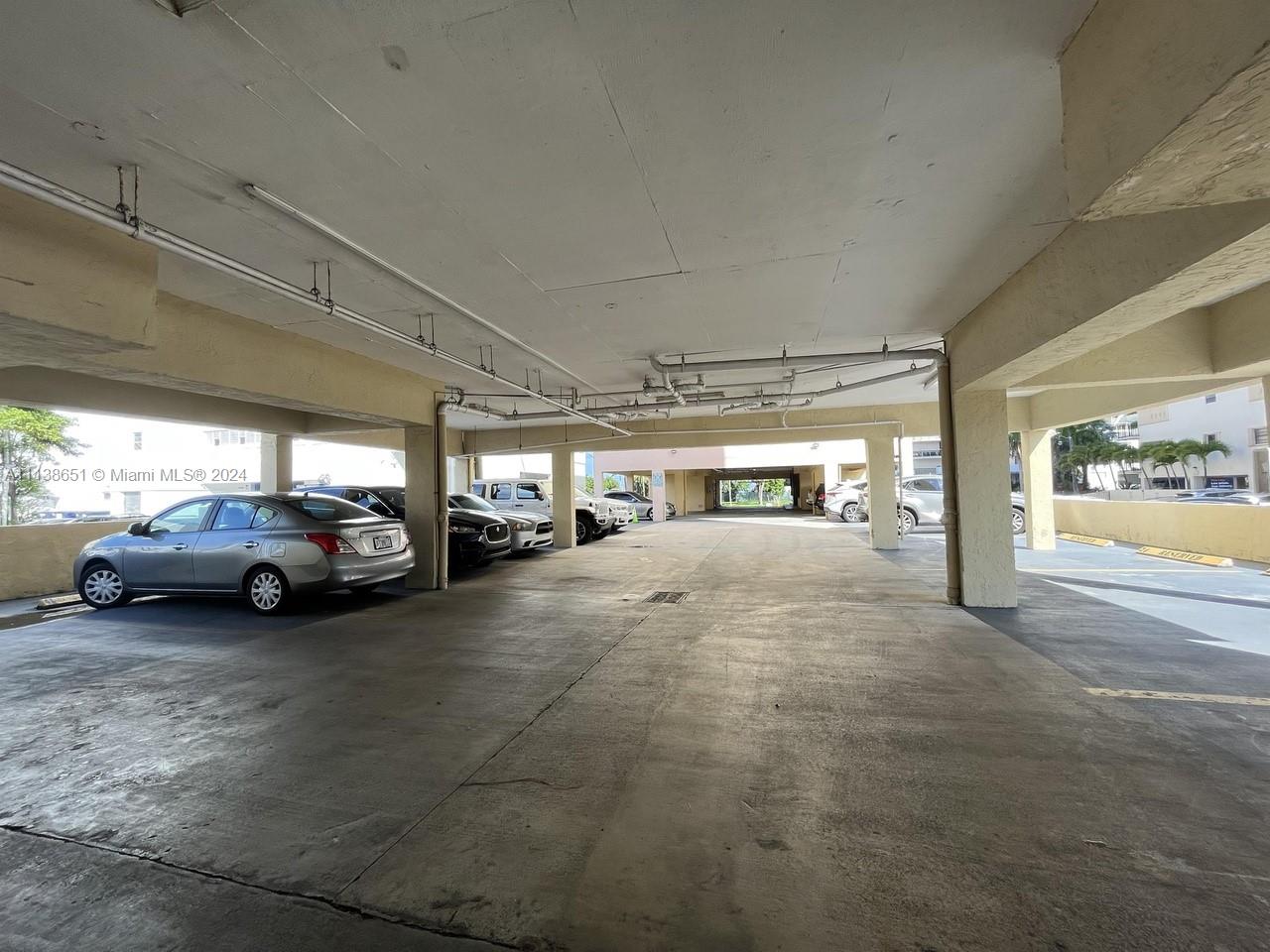 6445 Indian Creek Drive, Unit B16 Miami Beach, FL 33141 - Photo 17 of 18 a view of parking garage with cars parked