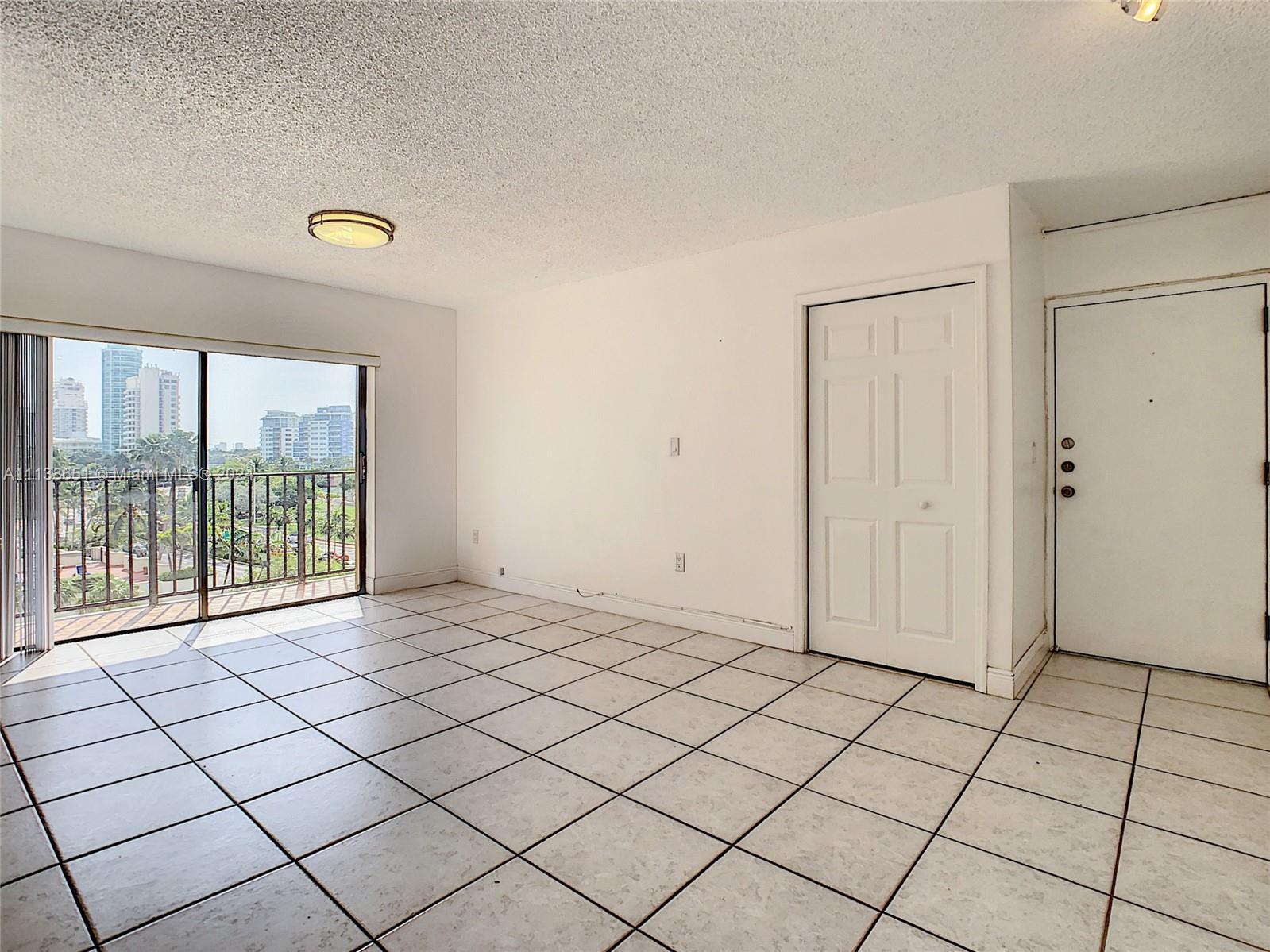 6445 Indian Creek Drive, Unit B16 Miami Beach, FL 33141 - Photo 6 of 18 a view of an empty room and window