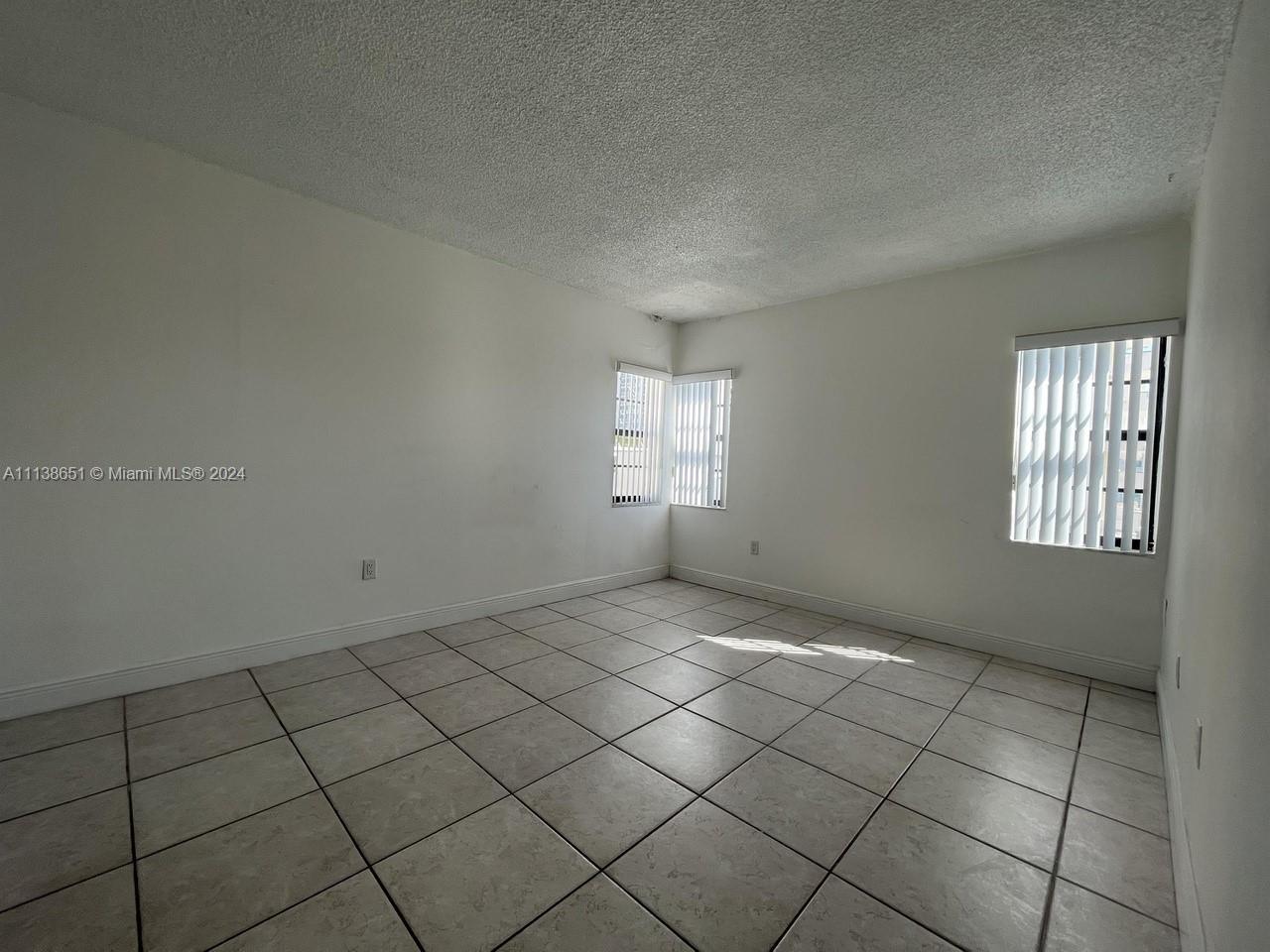 6445 Indian Creek Drive, Unit B16 Miami Beach, FL 33141 - Photo 8 of 18 an empty room with windows