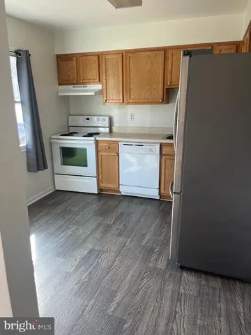 a kitchen with stainless steel appliances a refrigerator and a stove top oven