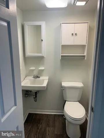 a bathroom with a sink toilet and a mirror