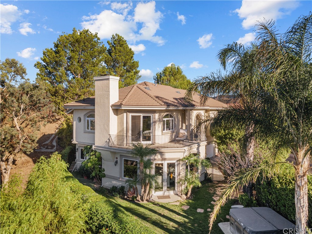 24806 Carlos Place Newhall, CA 91321 - Photo 1 of 44 a view of a white house with a yard table and chairs