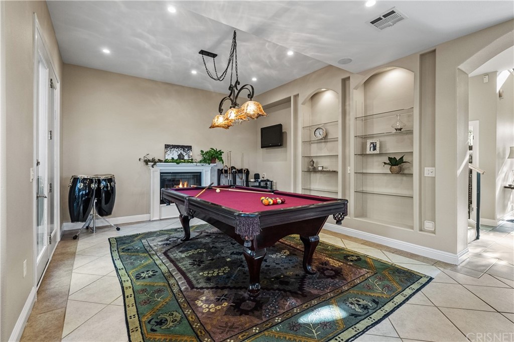 24806 Carlos Place Newhall, CA 91321 - Photo 16 of 44 a dining room with a table a chandelier and pool table