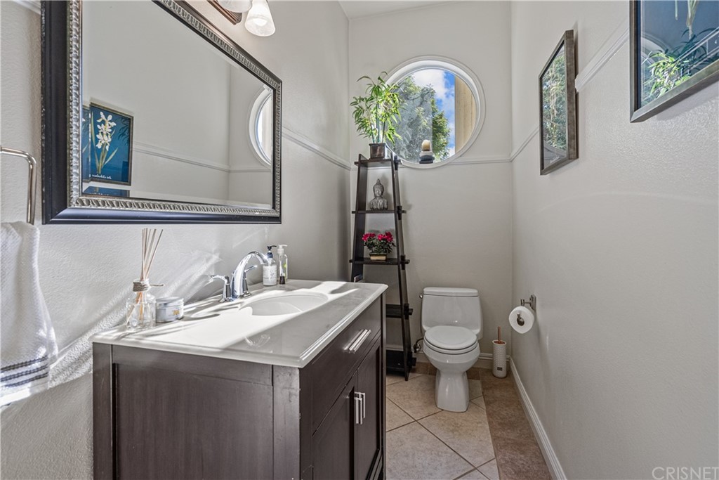 24806 Carlos Place Newhall, CA 91321 - Photo 19 of 44 a bathroom with a toilet sink and mirror