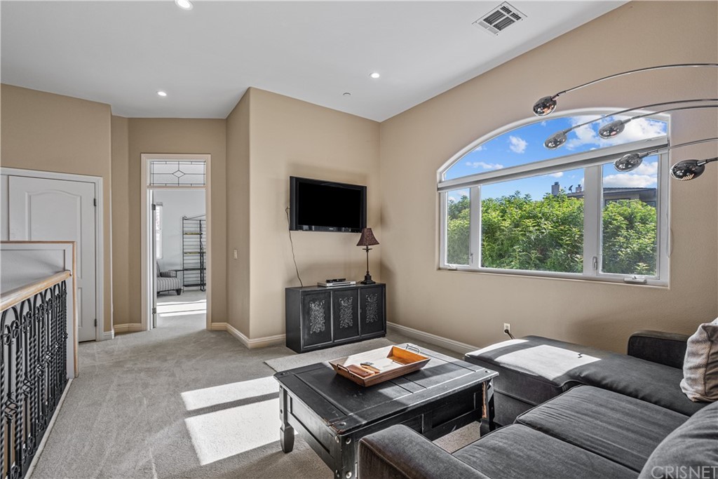 24806 Carlos Place Newhall, CA 91321 - Photo 23 of 44 a living room with furniture and a flat screen tv