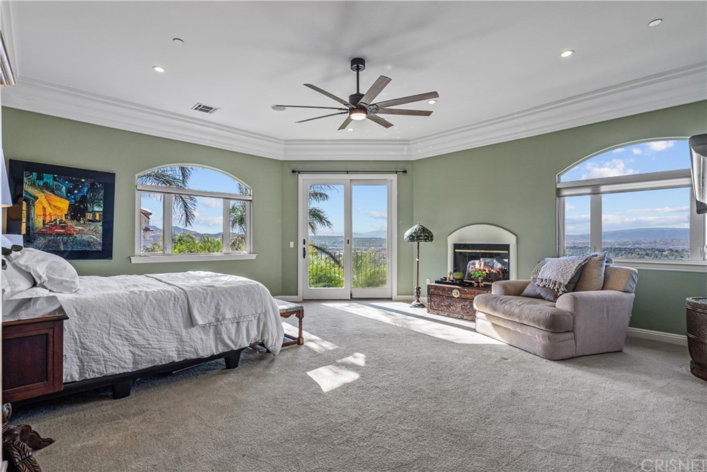 24806 Carlos Place Newhall, CA 91321 - Photo 25 of 44 a spacious bedroom with a bed couch and a large window