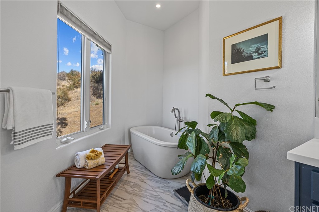 24806 Carlos Place Newhall, CA 91321 - Photo 30 of 44 a vase of flowers sitting on a table with a potted plant