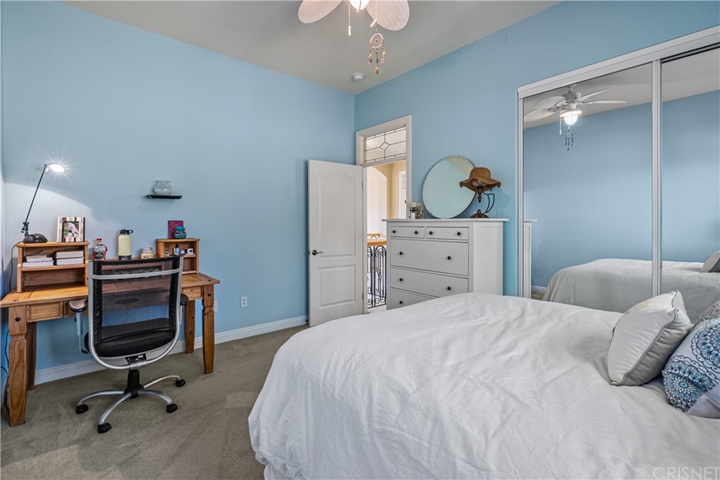 24806 Carlos Place Newhall, CA 91321 - Photo 37 of 44 a bedroom with a bed and a chandelier