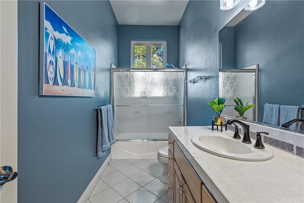 24806 Carlos Place Newhall, CA 91321 - Photo 38 of 44 a bathroom with a sink and a mirror