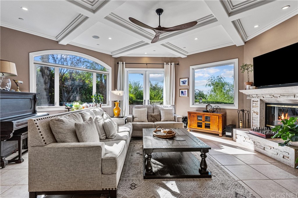 24806 Carlos Place Newhall, CA 91321 - Photo 6 of 44 a living room with furniture a fireplace and a flat screen tv