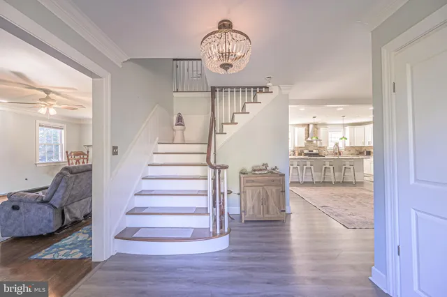 a view of entryway and hall with wooden floor