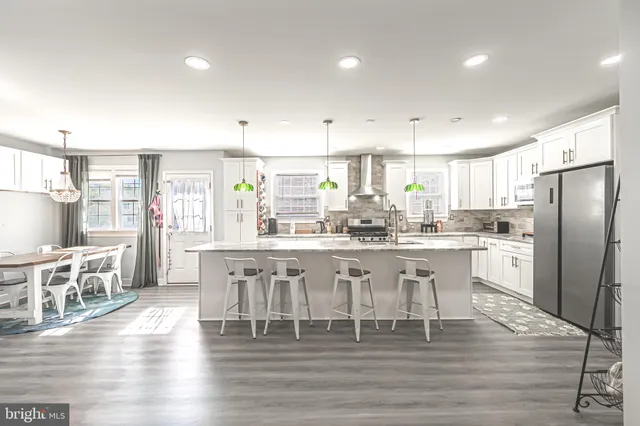 a large kitchen with a table and chairs