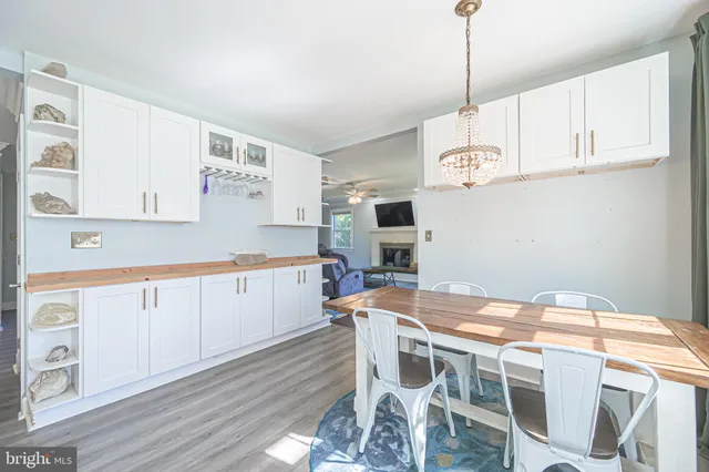 a kitchen with stainless steel appliances granite countertop a kitchen island a stove a table and chairs in it