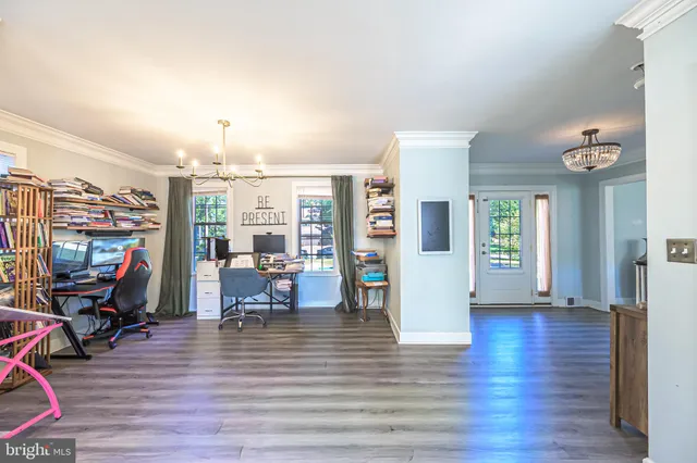 a view of a living room and dining room with wooden floor