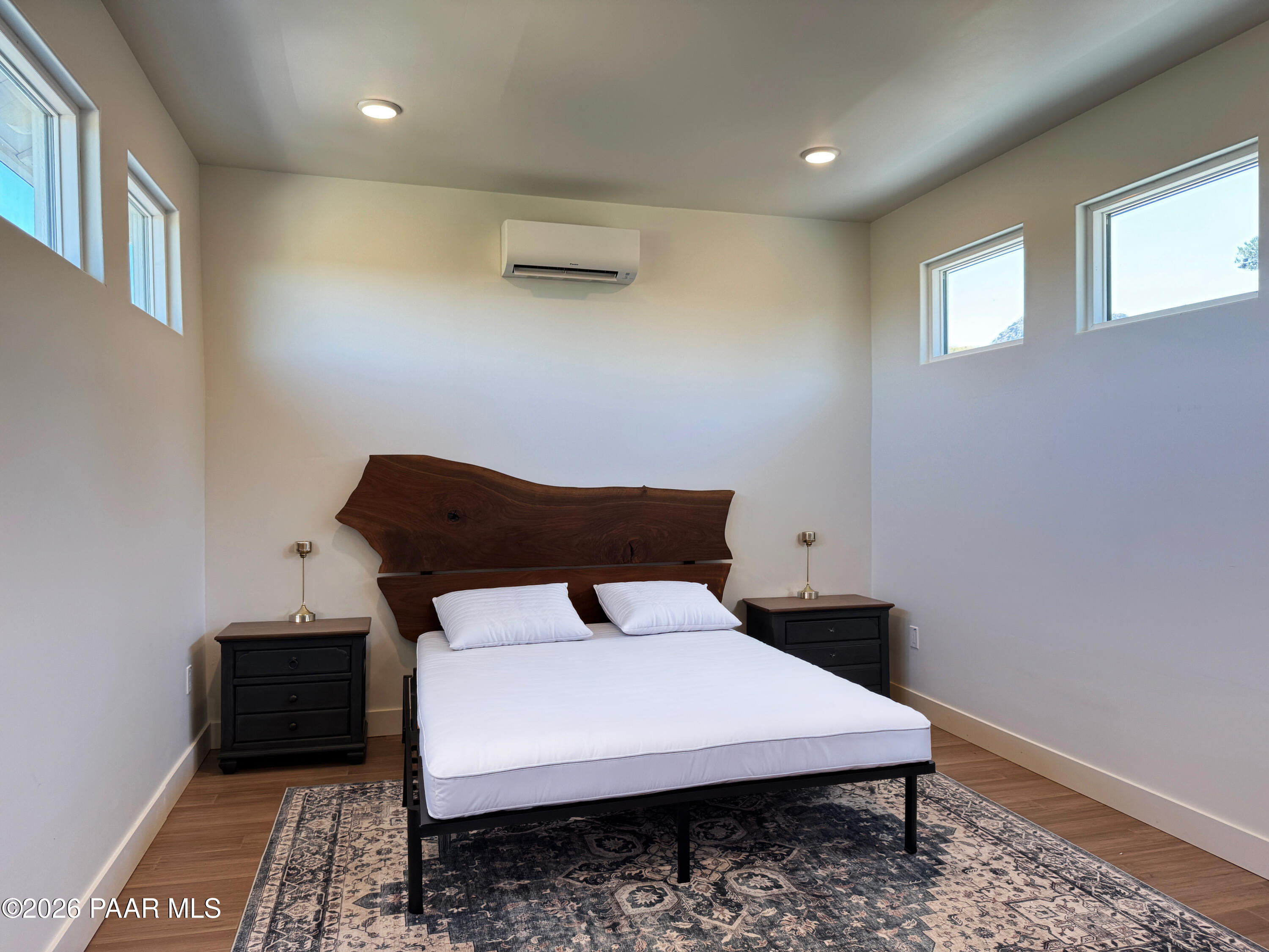 10255 North Chaos Ranch Road Prescott, AZ 86305 - Photo 55 of 101 a bed sitting in a room next to a window