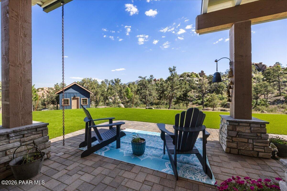 10255 North Chaos Ranch Road Prescott, AZ 86305 - Photo 60 of 101 a view of a chairs and table in the patio