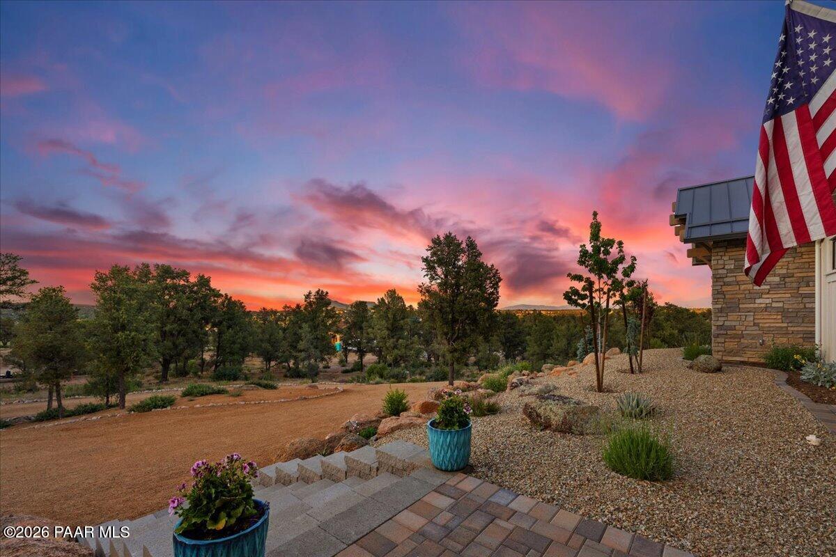 10255 North Chaos Ranch Road Prescott, AZ 86305 - Photo 75 of 101 a view of a backyard with a fountain and a fire pit